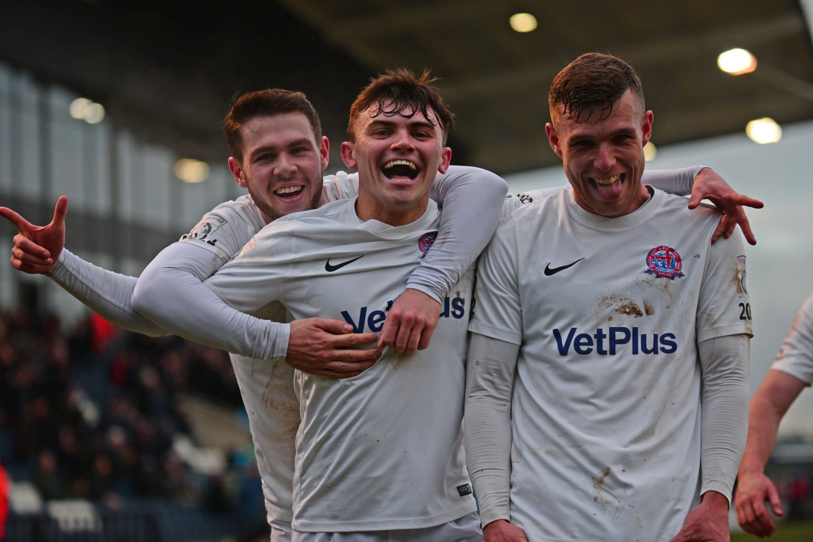 jonny-smith-centre-celebrates-with-luke-burke-and-jack-muldoon-after-scoring-fyldes-4th-of-the-game