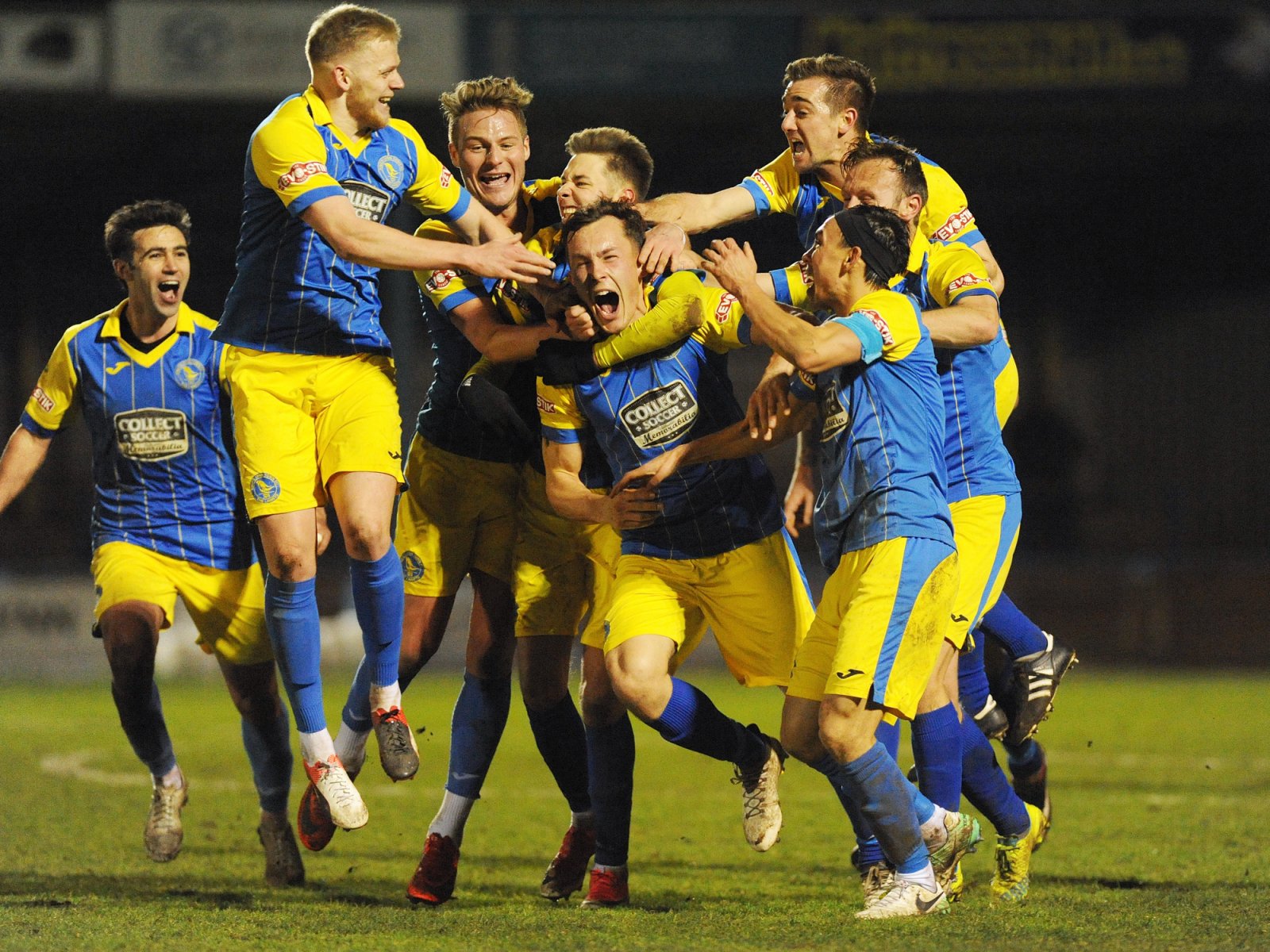 kings-lynn-goal-scorer-toby-hilliard-center-is-mobbed-by-team-mates_copy