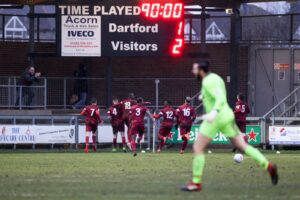 taylor-miles-of-chelmsford-is-congratulated-after-scoring-direct-from-a-corner-to-make-it-2-1-against-dartford