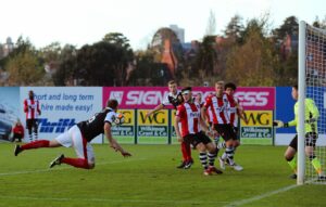 page-18-heybridge-swifts-lewis-godbold-heads-across-the-exeter-box