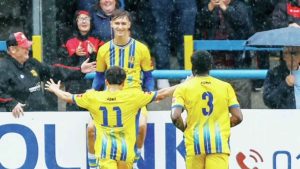 MOMENTS: Sittingbourne’s Mitchell May celebrates with team-mates after scoring at Dover in the Trophy