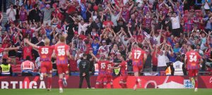 Aldershot Town's Jack Barham, centre, celebrates with his team-mates in front of the adoring Aldershot fans after scoring his side's first goal PICTURE: Alamy