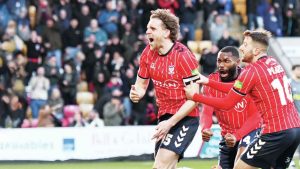 York City's Callum Howe wheels away in celebration at the LNER Community Stadium