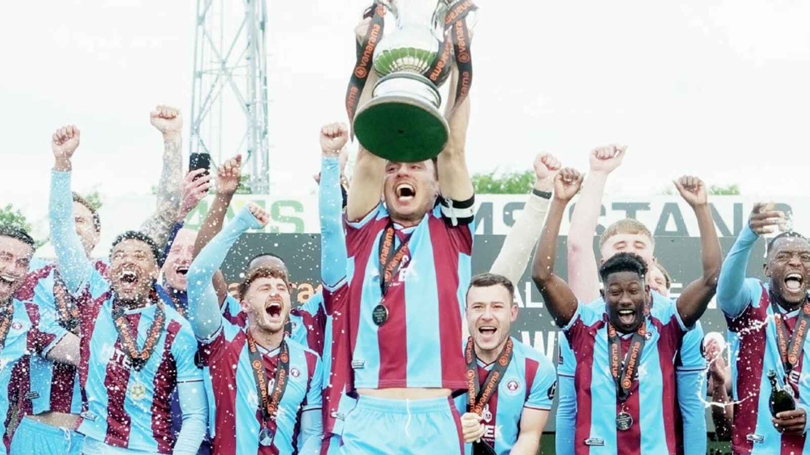 RAISE IT HIGH! Scunthorpe United captain Michael Clunan holds the trophy aloft
