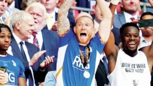 ECSTATIC: Oldham’s Joe Garner lifts the trophy