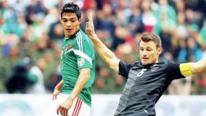 BIG COMPANY: Tommy Smith, of New Zealand, lunges to thwart Mexico’s Raul Jimenez during a 2014 World Cup play-off game