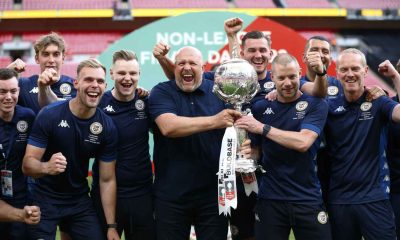 Alan Dunne, right, with Andy Woodman and the Bromley staff celebrating their FA Trophy win in 2022, holding the trophy together