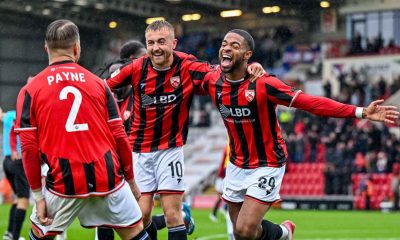 Elijah Dixon-Bonner celebrates with his Morecambe team-mates after finding the net in their seven-goal thriller against Wealdstone