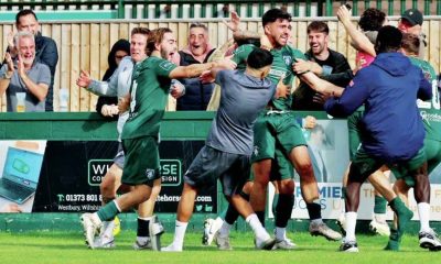Match winner Ali Sen is mobbed as Westbury United celebrate a famous FA Cup triumph