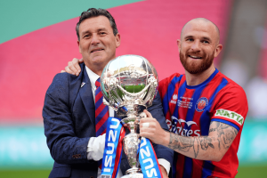 Tommy Widdrington, left, and Theo Widdrington lifting the Isuzu FA Trophy last season