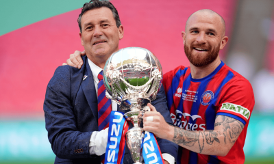 Tommy Widdrington, left, and Theo Widdrington lifting the Isuzu FA Trophy last season