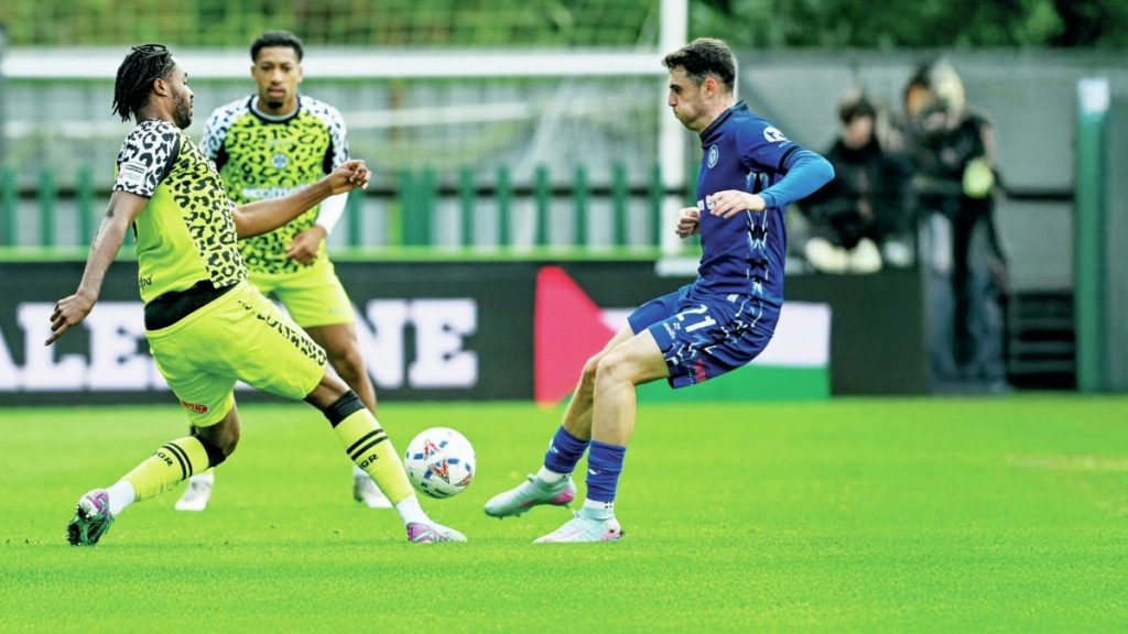 Forest Green’s James Balagizi, left, gets to the ball before Rochdale’s Connor McBride