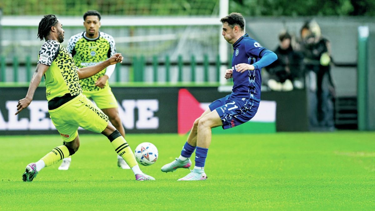 Forest Green’s James Balagizi, left, gets to the ball before Rochdale’s Connor McBride