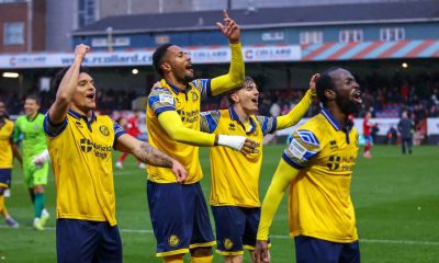 Josh Osude leads the celebrations after the final whistle for Woking