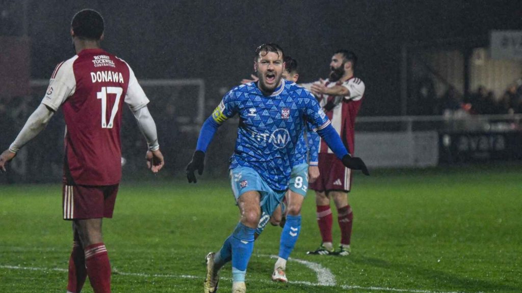 Ollie Pearce heads off towards the York City supporters in celebration of his winning goal
