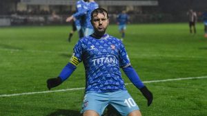 Ollie Pearce slides towards the York City supporters in celebration of his winning goal
