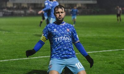 Ollie Pearce slides towards the York City supporters in celebration of his winning goal