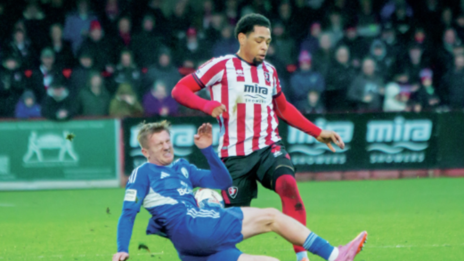 Buxton’s Luke Brennan tackles Cheltenham’s Arkell Jude-Boyd