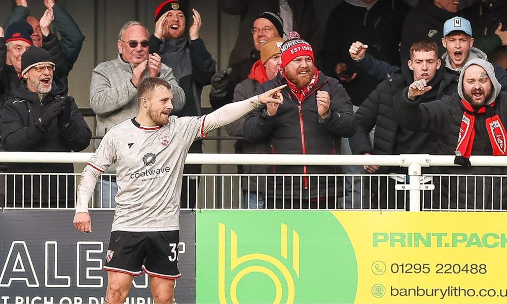 George Thomas celebrates after sealing Morecambe’s 2-0 win with his second goal at Brackley Town.