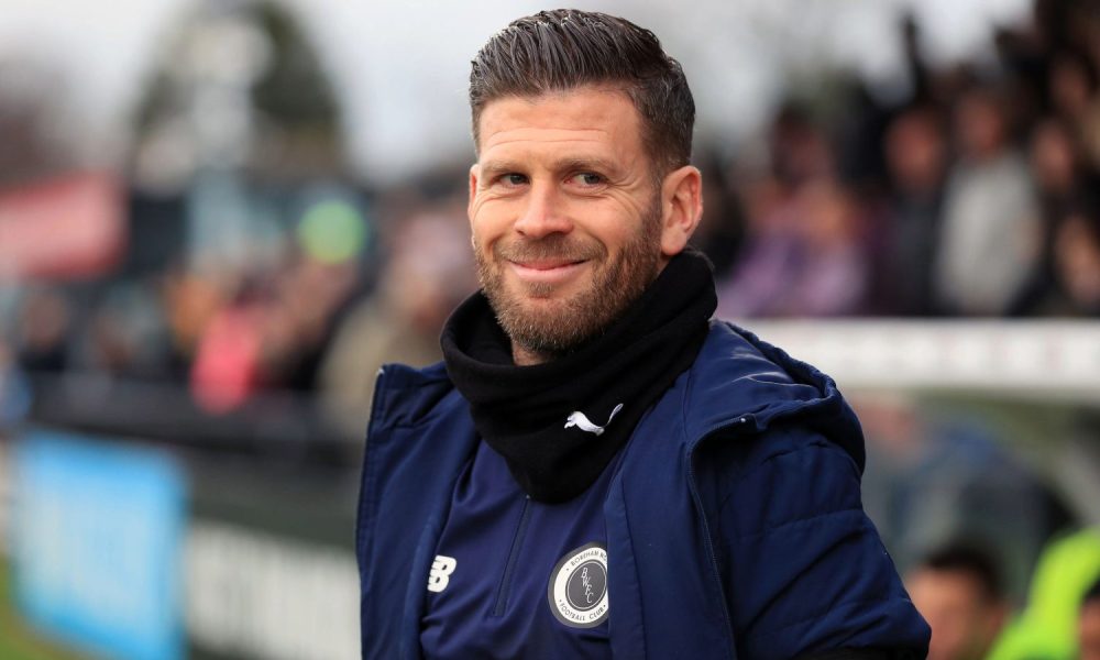 Boreham Wood manager Luke Garrard smiles on the touchline