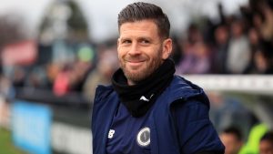 Boreham Wood manager Luke Garrard smiles on the touchline