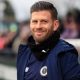 Boreham Wood manager Luke Garrard smiles on the touchline