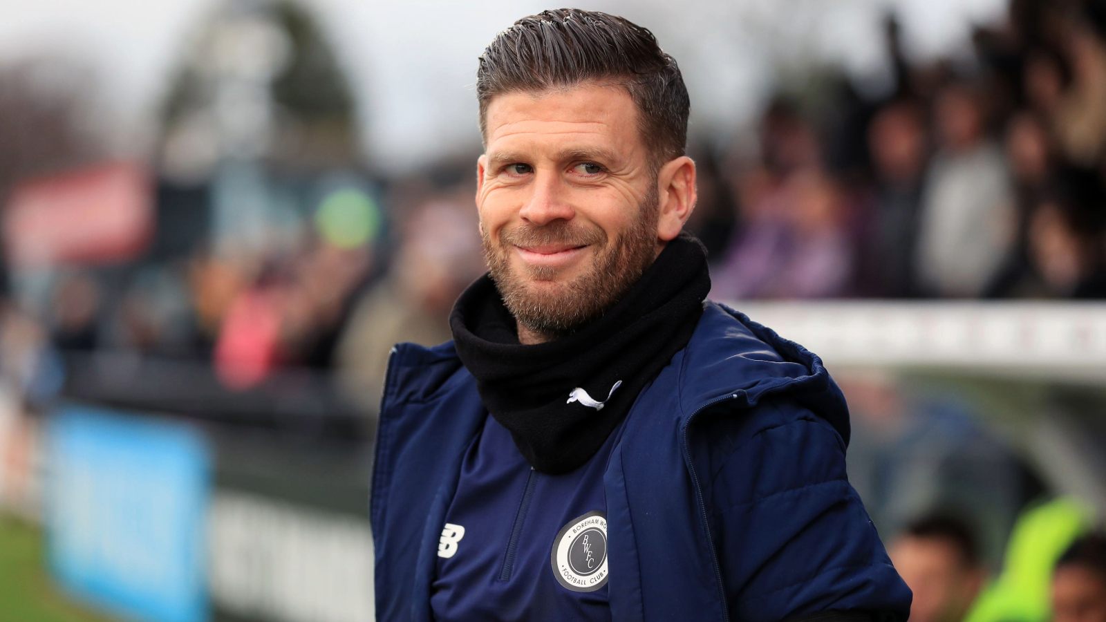 Boreham Wood manager Luke Garrard smiles on the touchline