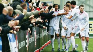 Macclesfield players celebrate James Edmondson’s fine second goal against Slough Town with fans. 