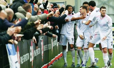 Macclesfield players celebrate James Edmondson’s fine second goal against Slough Town with fans. 