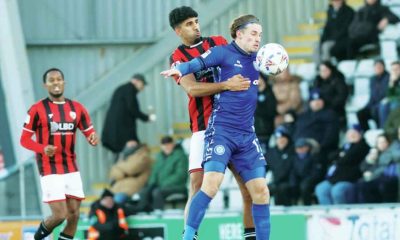 Morecambe’s Arjan Singh challenges Rochdale’s Joe Pritchard, right