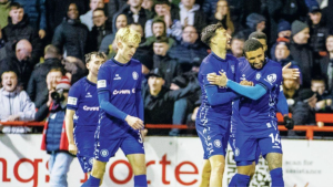 Rochdale’s Tyler Smith is mobbed after grabbing their third goal.