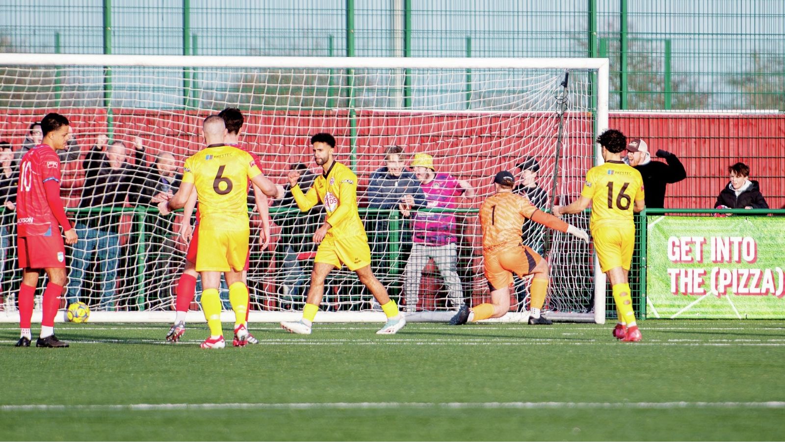 Poole’s Ik Hill (centre) celebrates after his penalty opener