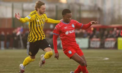 Morgan Roberts of Brackley Town chases Thabo Kuaho of Walton and Hersham for the ball during the Isuzu FA Trophy fourth round