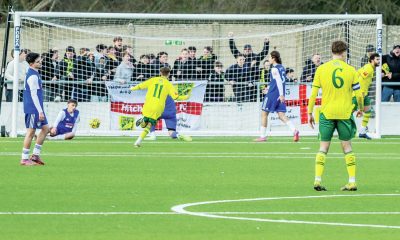 Hitchin fans behind the goal erupt as their team score