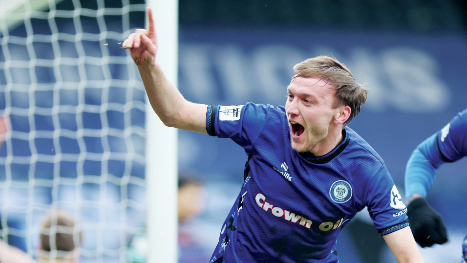 Dan Moss wheels away after scoring Rochdale’s winner, and, inset, Dale goalkeeper Ollie Whatmuff punches clear