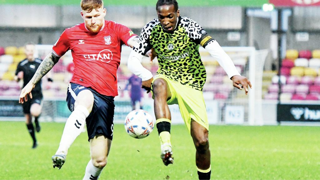 York City’s Josh Stones, left, battles Forest Green Rovers’ Laurent Mendy