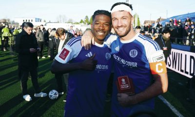 Macclesfield FC goalscorers Isaac Buckley-Ricketts, left, and Paul Dawson, right, celebrate Macclesfield’s historic victory over Crystal Palace
