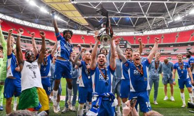 Oldham Athletic players celebrate with the trophy after winning last season’s National League play-off final at Wembley.