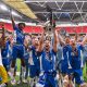 Oldham Athletic players celebrate with the trophy after winning last season’s National League play-off final at Wembley.