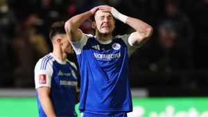 Sam Heathcote reacts after he scored an own goal