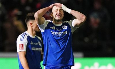 Sam Heathcote reacts after he scored an own goal