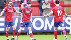 Aldershot scorer Sean Patton, centre, celebrates with Hady Ghandour, left, and Ryan Hill