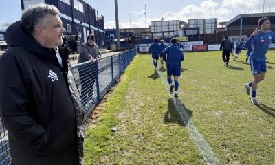 Danny Burkey watches on in his manager’s jacket