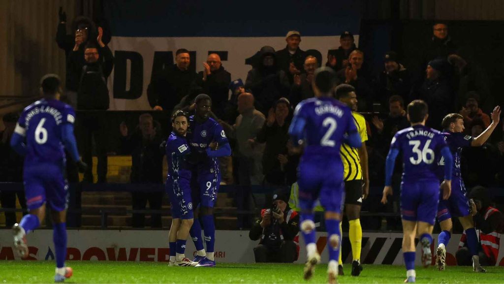 Emmanuel Dieseruvwe and Tarryn Allarakhia celebrate as Rochdale open the scoring against Brackley Town