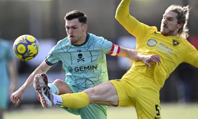 Harborough Town’s Alex Morris, in yellow, battles with Real Bedford’s Lee Watkins