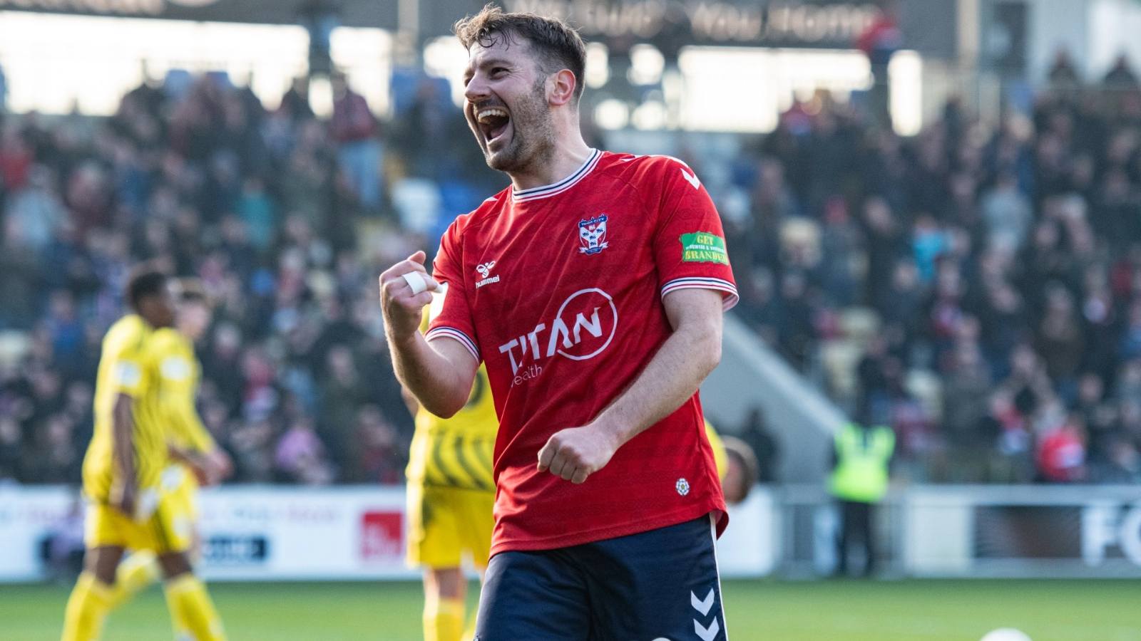Ollie Pearce celebrates scoring for York City against Brackley Town
