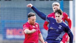 Leek Town’s Lucas Weir (R) and Stockton’s Stephen Thompson get stuck into their midfield tussle for possession.