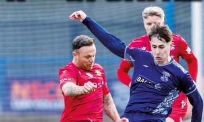 Leek Town’s Lucas Weir (R) and Stockton’s Stephen Thompson get stuck into their midfield tussle for possession.