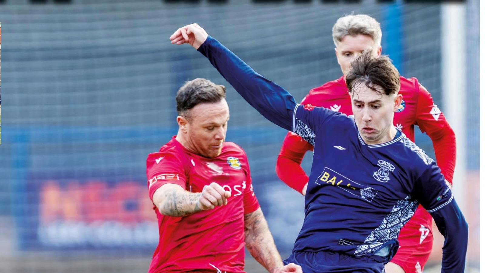 Leek Town’s Lucas Weir (R) and Stockton’s Stephen Thompson get stuck into their midfield tussle for possession.