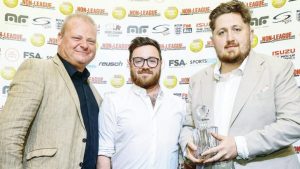 Farnham Town’s Harry Hugo, centre, and Frankie Hobbs, right, receive their award from the Non-League Show’s Tim Fuell